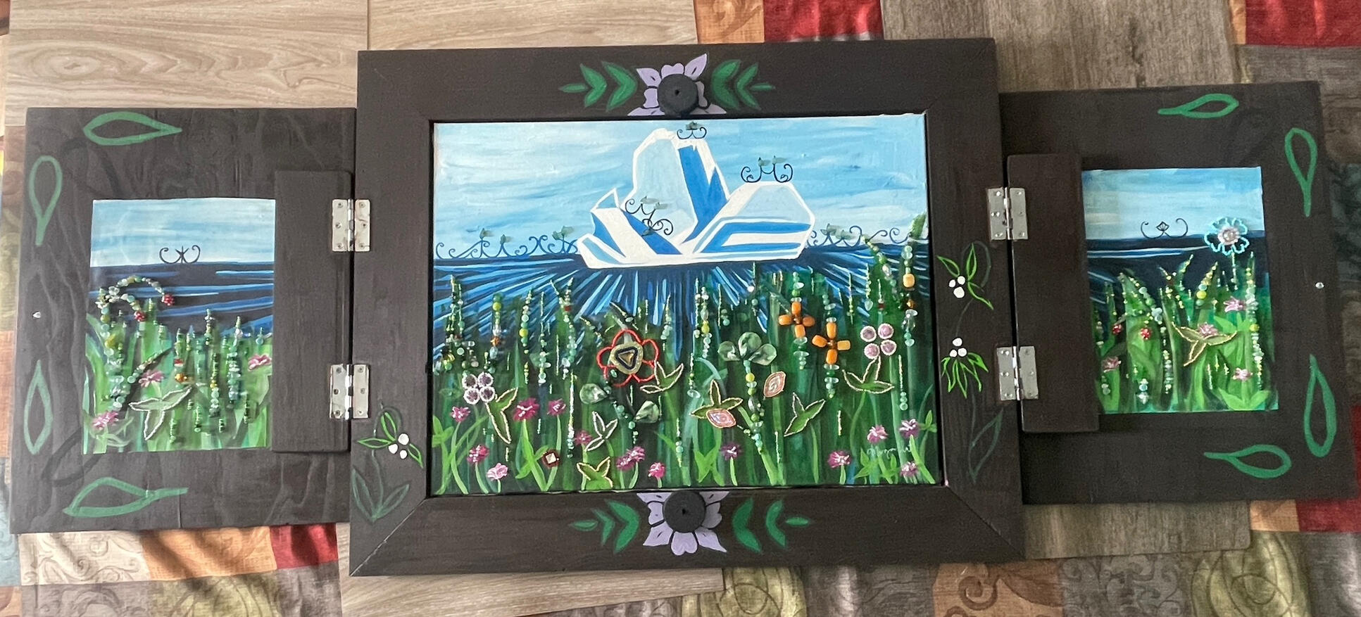 Lewis Hills (Open view) Dimensions: 28 in x 64 in Medium: Acrylic and Beadwork on canvas, housed in wooden cabinet Date: 2025 Lewis Hills (Open view) Dimensions: 28 in x 64 in Medium: Acrylic and Beadwork on canvas, housed in wooden cabinet Date: 2025